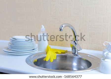Dishes drying near  metal sink