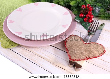 Set of utensil for romantic dinner, on table, on light background
