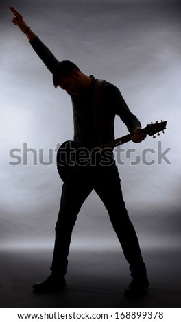 Guitarist silhouette on dark gray background