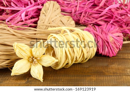 Decorative straw for hand made, heart and flower of straw, on wooden background