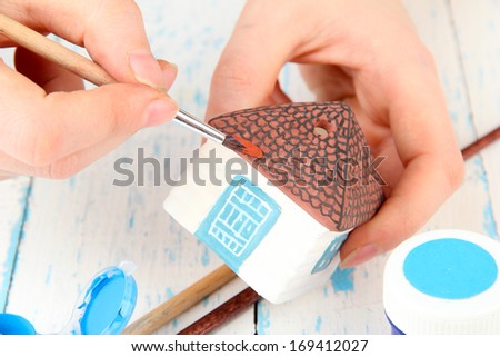 Hands paints on hand made ceramic house and  art materials