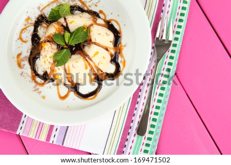 Panna Cotta with chocolate  and caramel sauce, on color wooden background