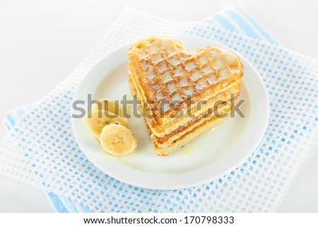 Sweet Belgium waffles with banana, isolated on white