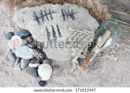 Counting days by drawing sticks on stone with stones and shells on sand background
