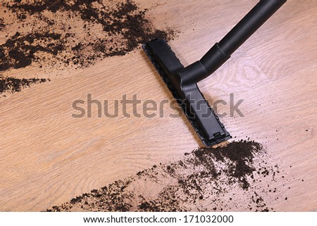 Vacuuming floor in house