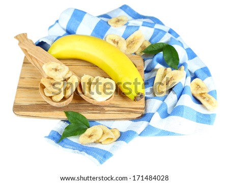 Fresh and dried banana slices on wooden board, isolated on white