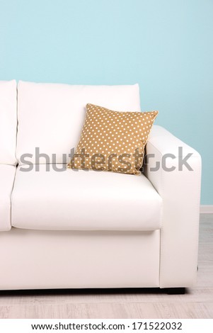 White sofa close-up in room on blue background