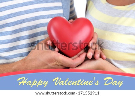 Beautiful loving couple with heart isolated on white