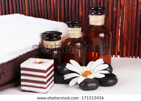 Beautiful spa setting with flower on table on bamboo background
