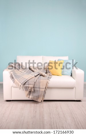 White Sofa In Room On Blue Background