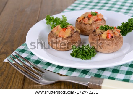 Stuffed mushrooms on plate on table close-up