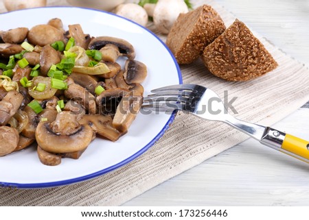 Delicious fried mushrooms on plate on table close-up