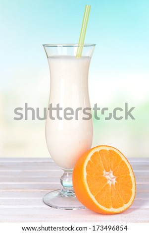 Milk shake on table on light blue background