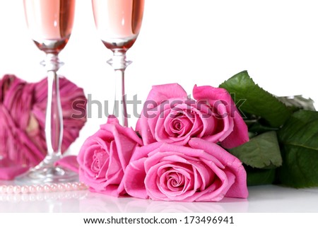 Composition with pink sparkle wine in glasses, and pink roses isolated on white