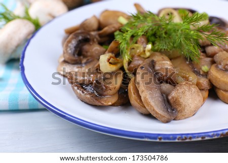 Delicious fried mushrooms on plate on table close-up
