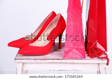 Beautiful red female shoes and shop bags