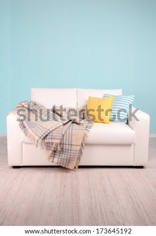 White sofa in room on blue background White sofa in room on blue background