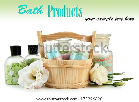 Aromatic salts in glass bottles, in wooden bucket, isolated on white