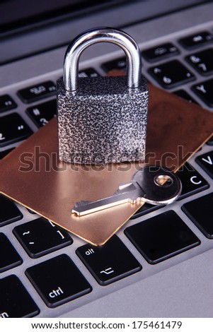 Credit card and lock on keyboard close up