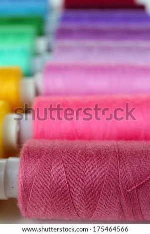Colored spools of threads close up