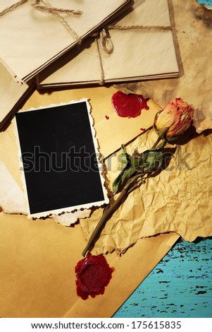 Composition with blank old photos, paper, letters on color wooden background