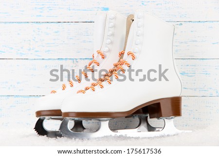 Figure skates on wooden background