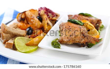 Homemade fried chicken drumsticks with vegetables on plate isolated on white