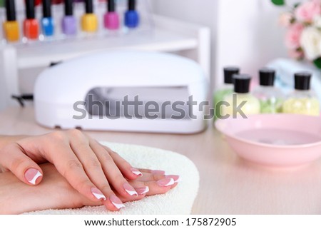 Young woman getting manicure in beauty salon