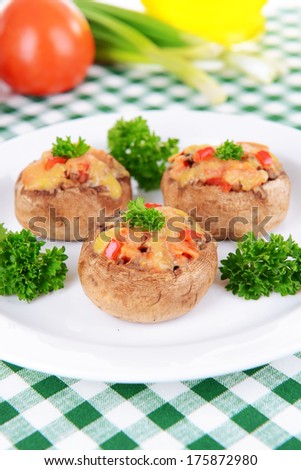 Stuffed mushrooms on plate on table close-up