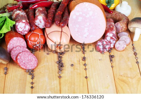 Different sausages on wooden table close-up