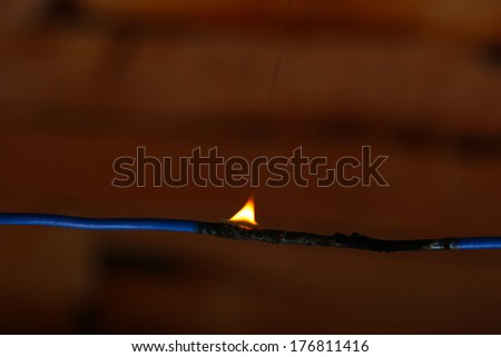 Short circuit, burnt cable, on dark color background