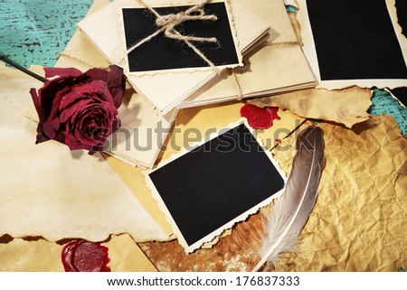 Composition with blank old photos, paper, letters on color wooden background
