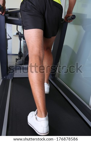 Guy on treadmill in gym