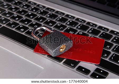 Credit card and lock on keyboard close up