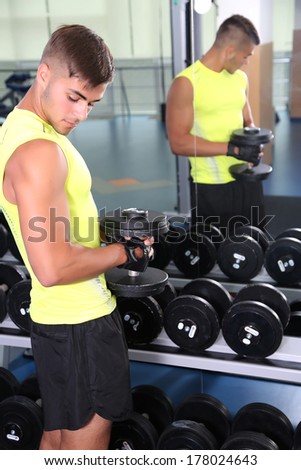 Guy with dumbbells in gym