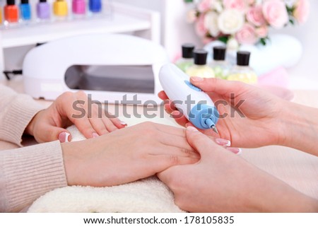 Manicure process in beauty salon close up