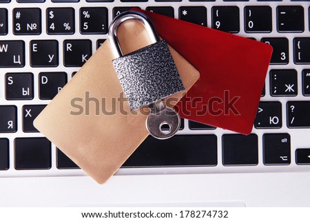 Credit cards and lock on keyboard close up