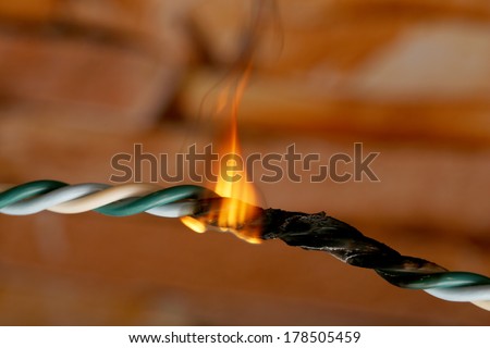 Short circuit, burnt cable, on dark color background