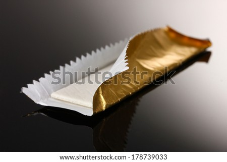 Chewing gum on the wrapping foil on gray background