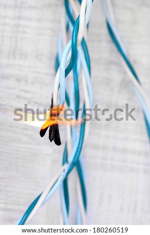 Short circuit, burnt cable, on color wooden background