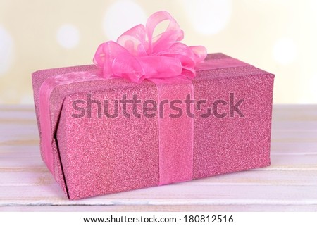 Gift box on table on light background