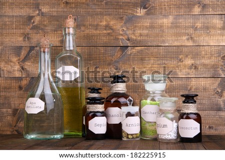 Historic old pharmacy bottles with label and Old-fashioned weight scales, on wooden background