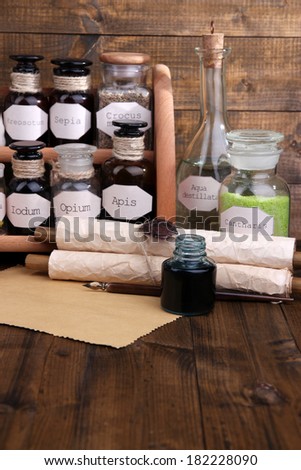Composition with empty page and historic old pharmacy bottles with label   on wooden background