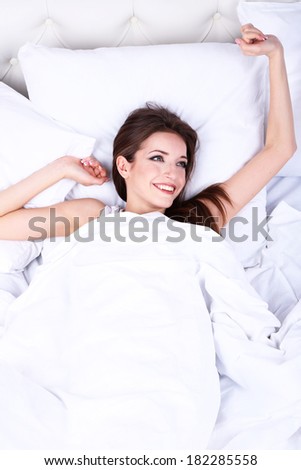 Young beautiful woman woke up in bed close-up