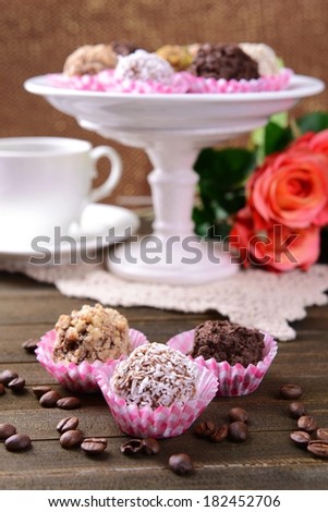 Set of chocolate candies on table on brown background