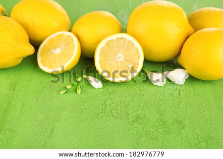 Fresh lemons and lavender on green table