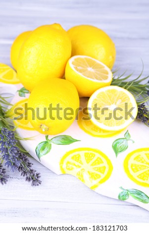 Still life with fresh lemons and lavender on light background