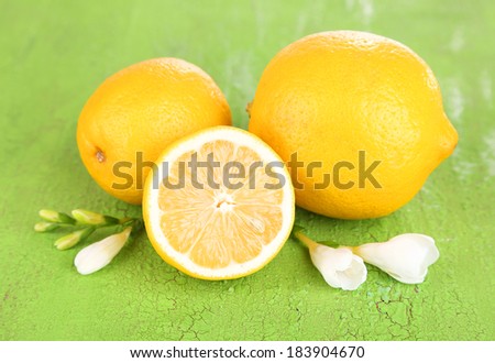 Fresh lemons and lavender on green table