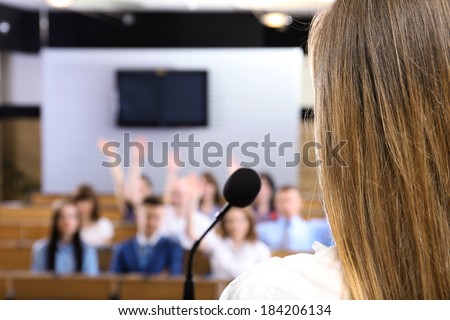 Businesswoman is making speech at conference room