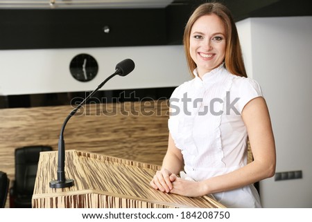 Businesswoman is making speech at conference room